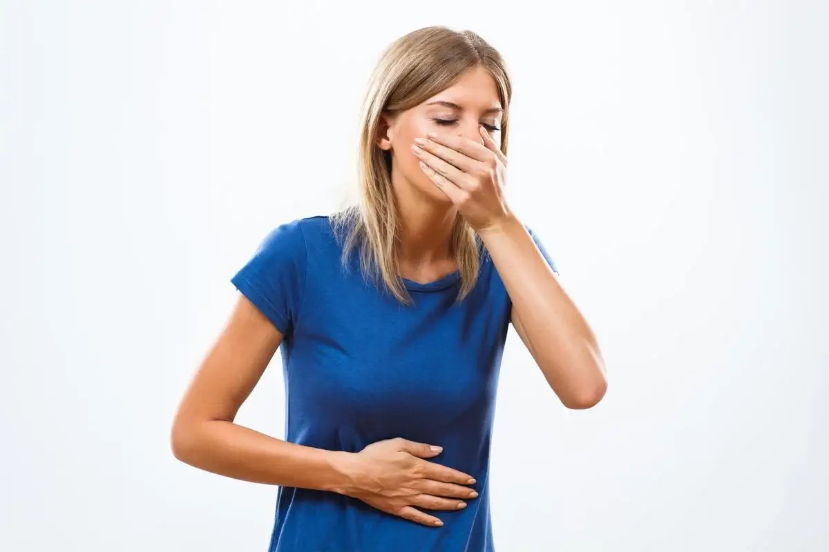 Femeie cu greață și stare de rău, simptome care pot indica un infarct la femei